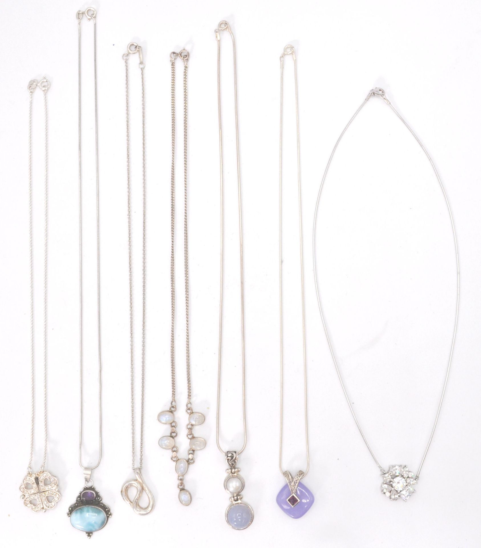 A collection of silver necklace chains to include pendants to each. Fine linked with stone set, fine