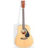 A Yamaha six string acoustic guitar model FG - 403