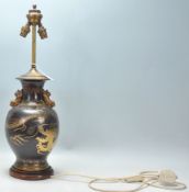 A good vintage Chinese brass table lamp having a black painted ground with dragon and cloud