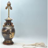 A good vintage Chinese brass table lamp having a black painted ground with dragon and cloud