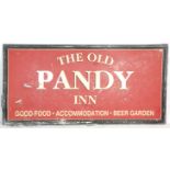 A large metal Welsh pub sign for 'The Old Pandy Inn, Good Food-Accommodation-Beer Garden'. The