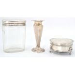 A group of three silver hallmarked wares to include a glass faceted pot having a silver cover