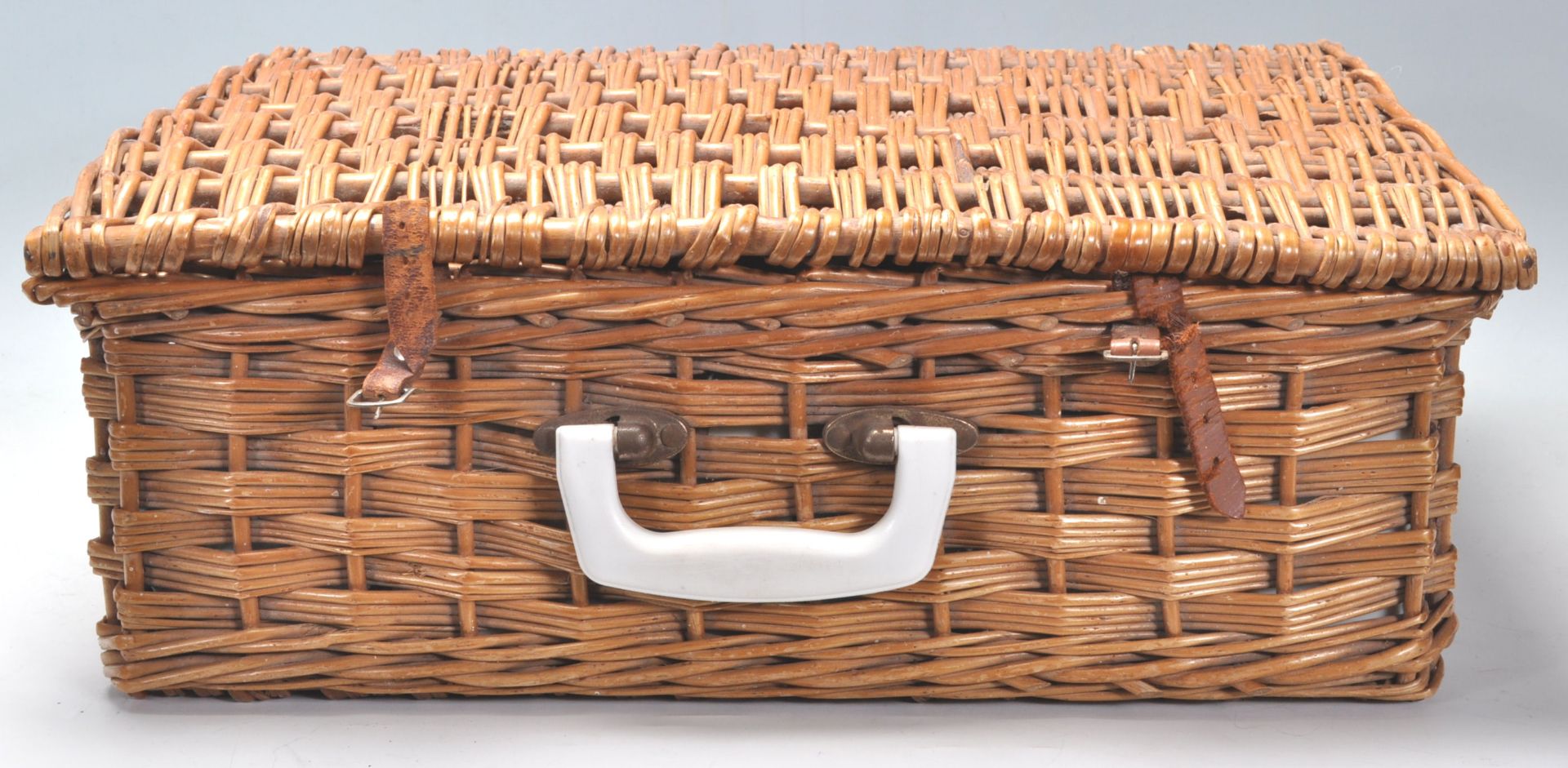 A vintage 1950s picnic basket / hamper fitted with plastic wares.