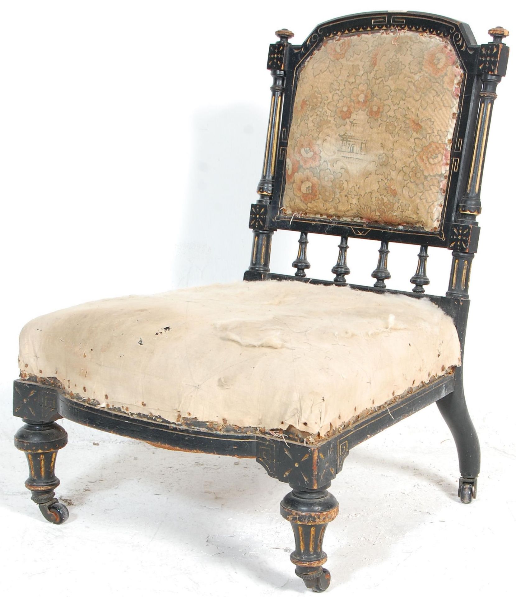 A Victorian 19th century Aesthetic movement nursing chair. Raised on turned, tapering legs with