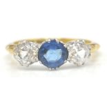 An Edwardian period 18ct gold and platinum 3 stone ring. The ring set with 3 paste stones of round