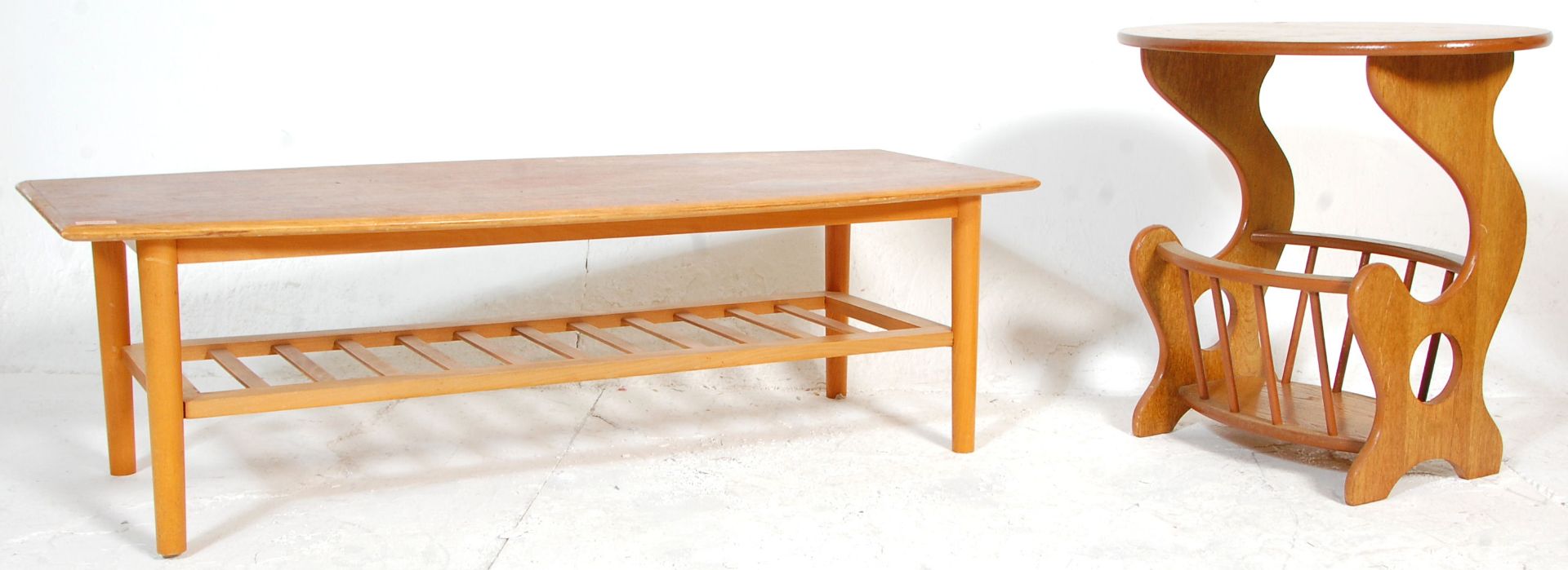 A retro 20th Century Danish inspired surfboard top teak coffee table raised on tapering legs with