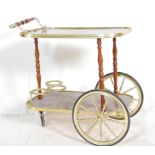 A vintage retro two tier Italian style drinks trolley, brass gallery surround to each tier raised on