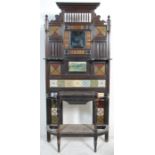 A 19th Century Victorian mahogany framed tiled hall stand with a carved pediment to the top, and a