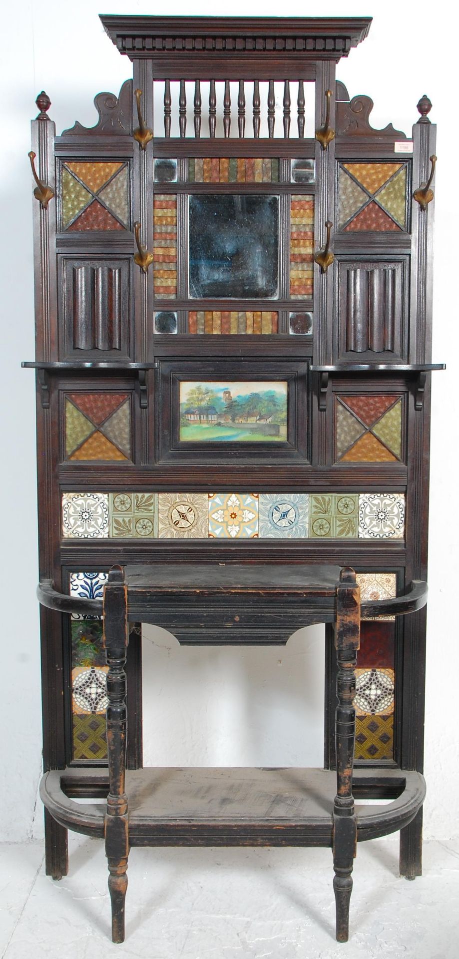 A 19th Century Victorian mahogany framed tiled hall stand with a carved pediment to the top, and a
