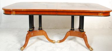 A large impressive extendable regency revival dining table consisting of a maple, satinwood, ebony &
