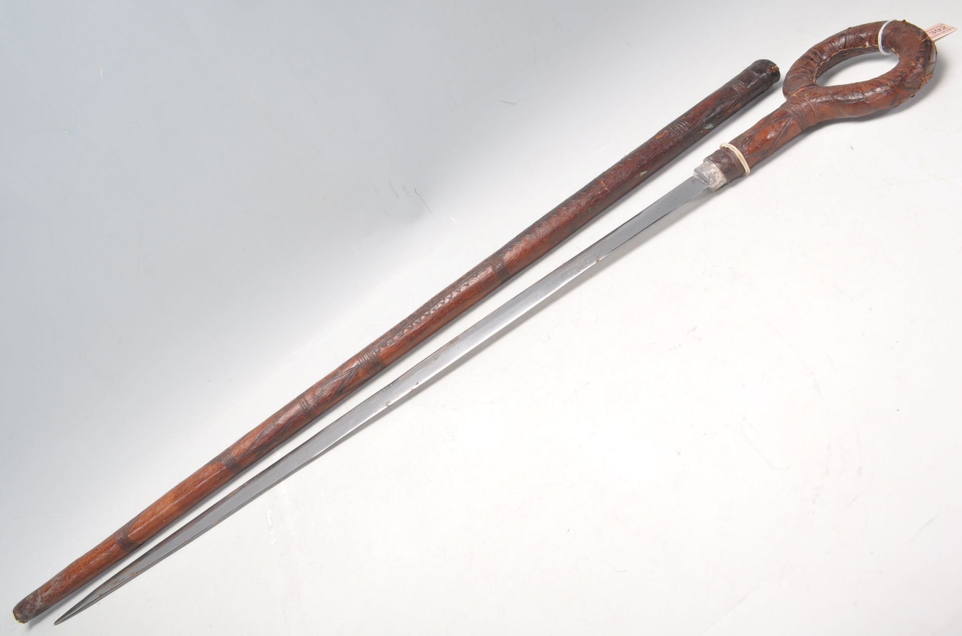 A 19th Century Victorian sword stick / walking stick having leather covered scabbard and hoop handle