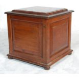 An early 19th Century mahogany cellarette / wine cooler with carved square panels set on bun feet.