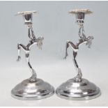 A pair of early 20th Century Art Deco nude female candlesticks raised on circular bases. Each
