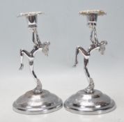 A pair of early 20th Century Art Deco nude female candlesticks raised on circular bases. Each