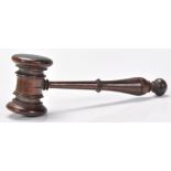 A 19th century carved lignum wood auctioneers gavel. The turned wooden handle with knob finial end