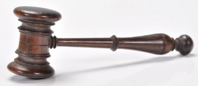 A 19th century carved lignum wood auctioneers gavel. The turned wooden handle with knob finial end