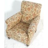 A Victorian 19th century armchair in the manner of Howard & Sons, London. Raised on turned legs with