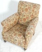 A Victorian 19th century armchair in the manner of Howard & Sons, London. Raised on turned legs with