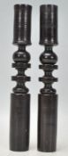 A pair of early 20th Century turned ebony candlesticks having knopped design centres. Measures 22.