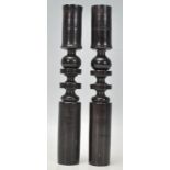 A pair of early 20th Century turned ebony candlesticks having knopped design centres. Measures 22.