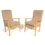 A pair of vintage retro mid 20th Century open arm chairs having wooden frames with brown upholstered