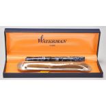 A vintage Waterman fountain ink writing pen having a brown plastic marble body with a 14ct gold