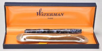 A vintage Waterman fountain ink writing pen having a brown plastic marble body with a 14ct gold