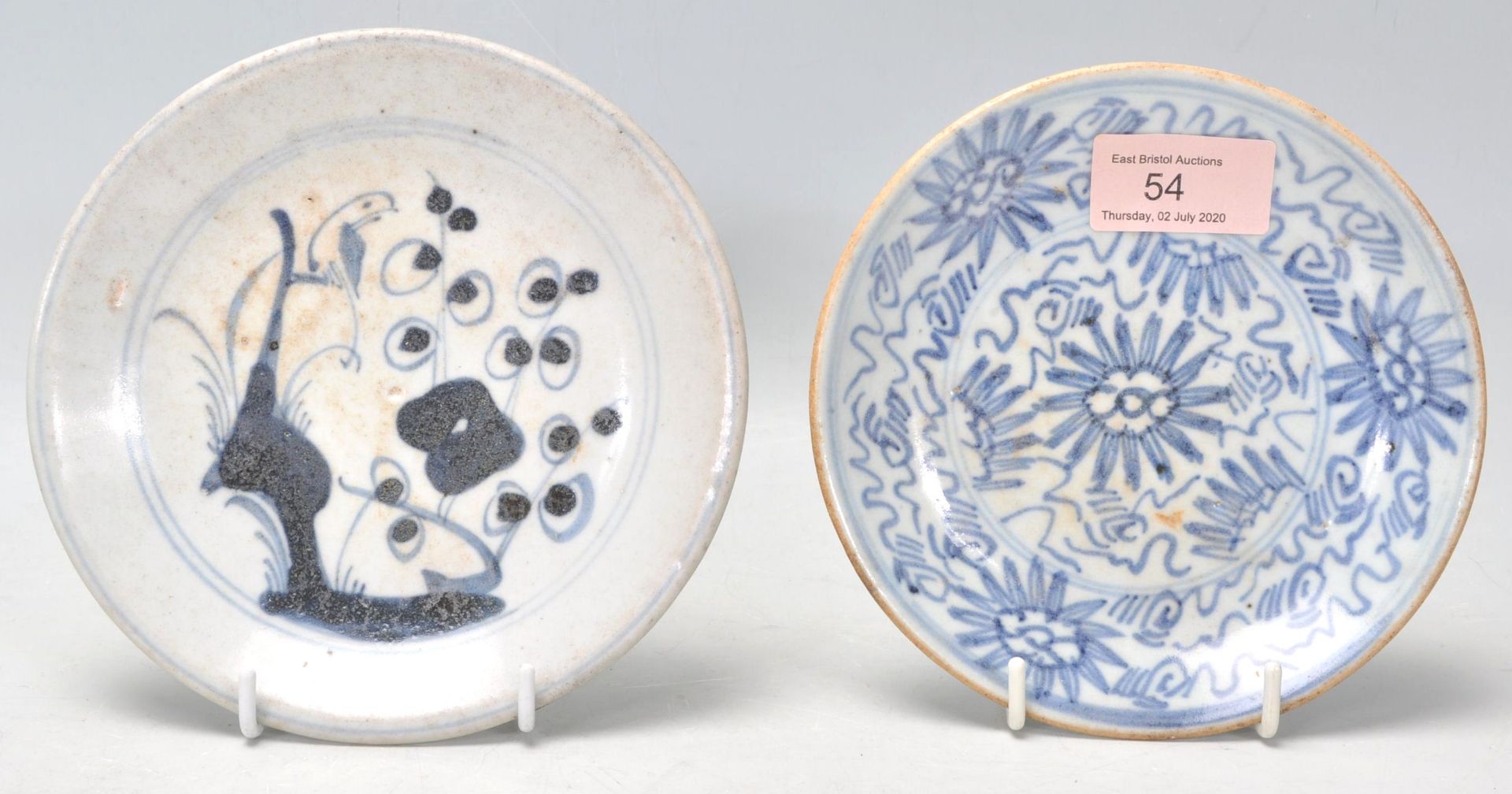 An 18th Century Japanese blue and white small plate having hand painted decoration of a perched bird