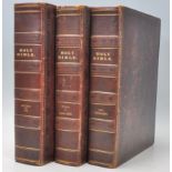 A good group of three leather bound Holy Bible books having gilt tooled spines with leather worked