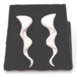 A pair of stamped sterling silver and mother of pearl lightning bolt style earrings terminating in a