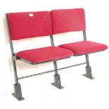 A set of two vintage retro 20th Century folding cinema / theatre chairs having red upholstered block