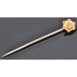 A 9ct gold toped tie pin having wire work and ball finial decoration set with a single diamond chip.
