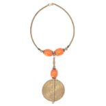 An Ashanti tribal necklace with a brass choker, faux amber beads above a large disc made using the