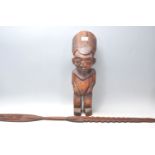 An African tribal fertility figurine having a large round stylised head dress, possibly Nigerian,