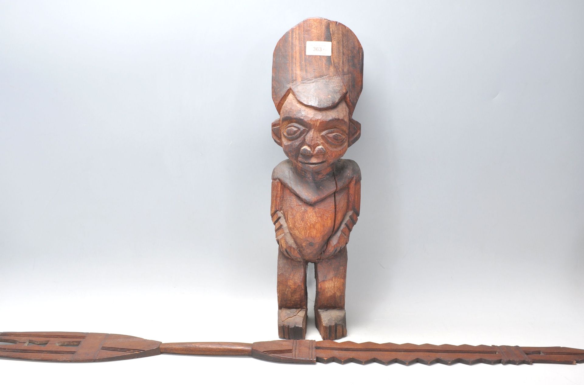 An African tribal fertility figurine having a large round stylised head dress, possibly Nigerian,