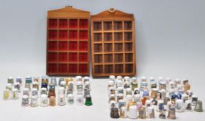 A collection of vintage bone china thimbles to include a wide variety of souvenir thimbles from