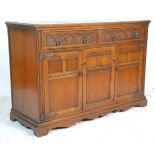 An early 20th Century 1930's Jacobean revival oak sideboard credenza having twin drawers with ring
