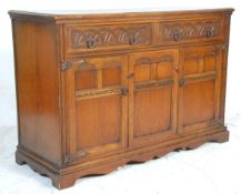 An early 20th Century 1930's Jacobean revival oak sideboard credenza having twin drawers with ring