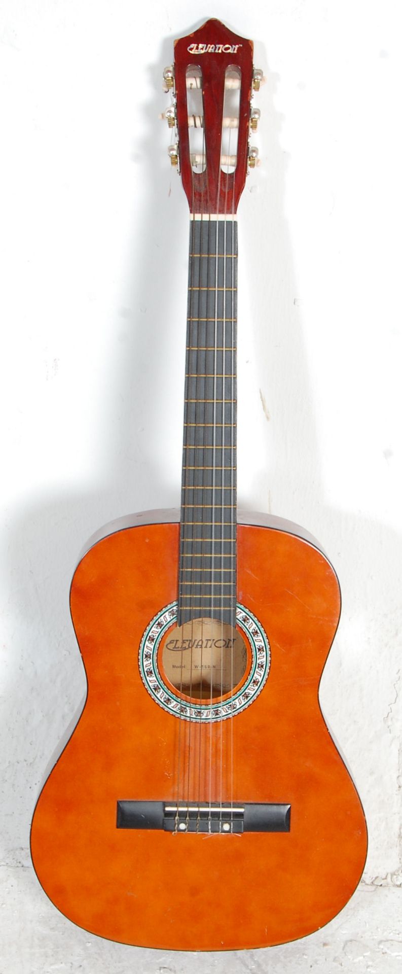 A vintage Elevation made six string acoustic guitar having inlaid geometric pattern decoration