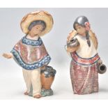 A pair of Lladro ceramic figurines in the form of a Mexican boy wearing a Sombrero and a poncho