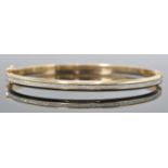 A hallmarked 9ct white and yellow gold and bracelet / bangle. The bracelet having white gold