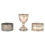 Two English silver hallmarked napkin rings with both having engine turned decoration with one