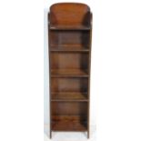 An early 20th Century Arts & Crafts tall oak upright bookcase open window cabinet having five fitted