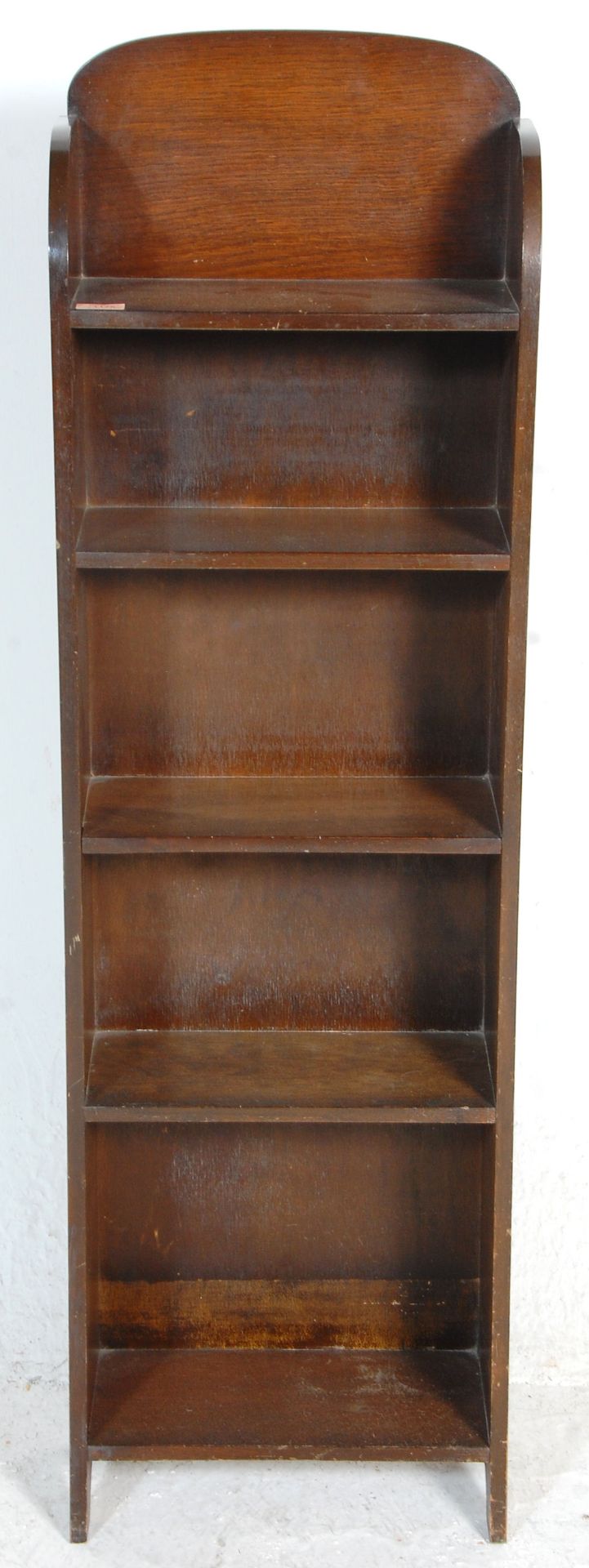 An early 20th Century Arts & Crafts tall oak upright bookcase open window cabinet having five fitted