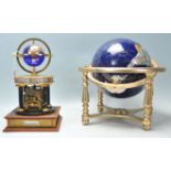 A 20th Century desk top ornamental blue terrestrial globe raised on a brass gimbal stand with