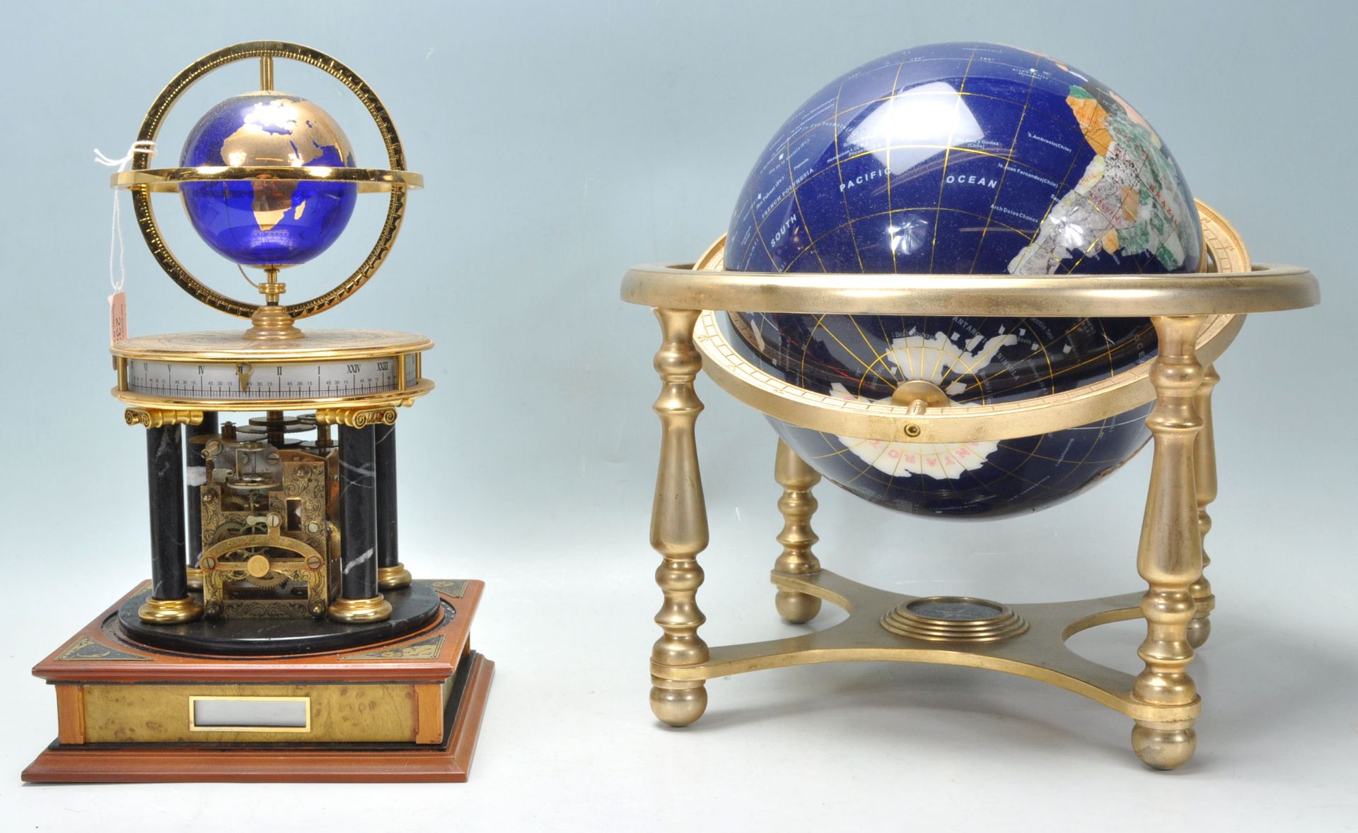 A 20th Century desk top ornamental blue terrestrial globe raised on a brass gimbal stand with