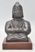 An usual Eastern clay / terracotta figure of Buddha seated crossed legged raied on a wooden plinth