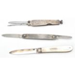 A group of three folding fruit knives to include a mother of pearl handle with a silver panel and