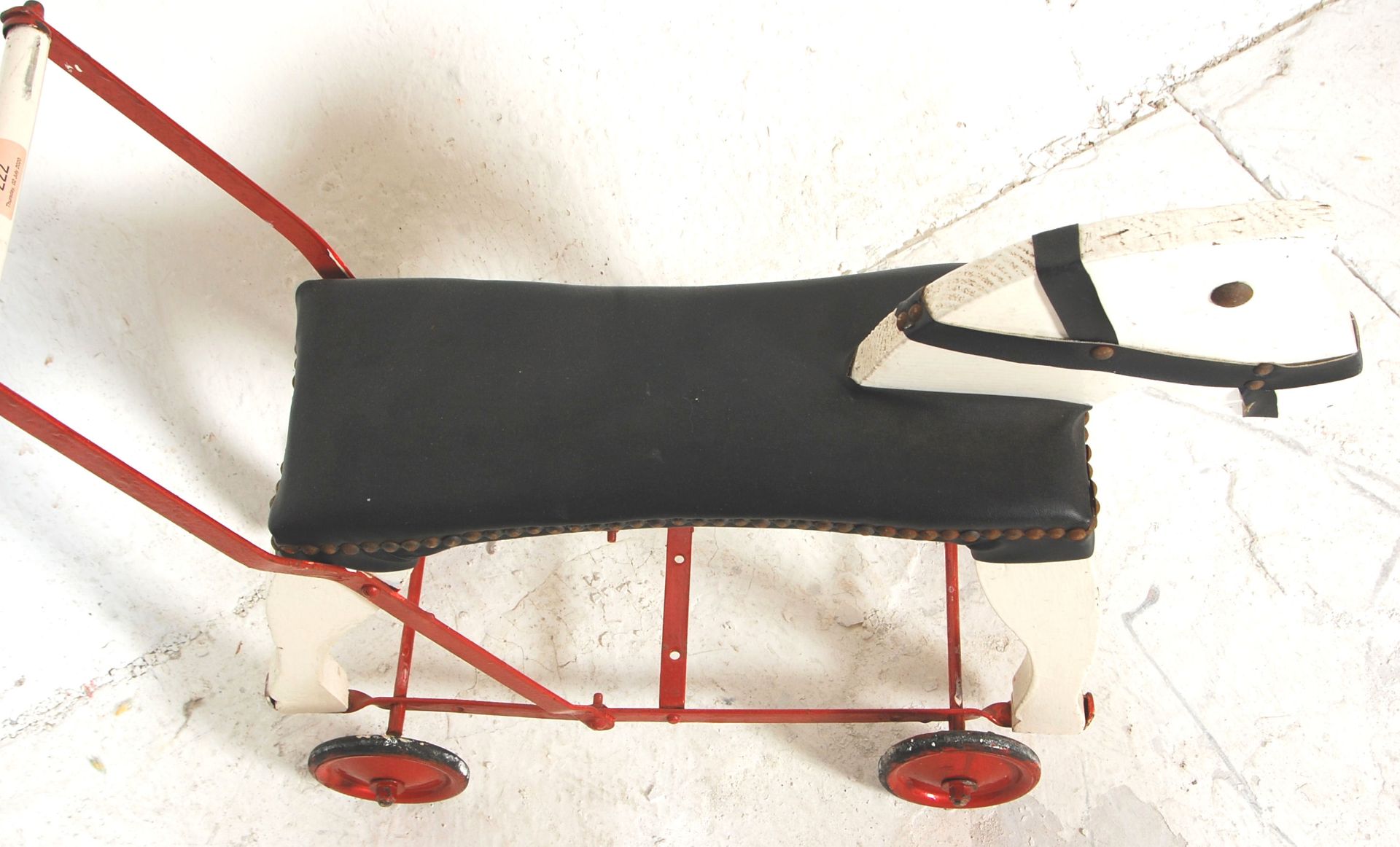 A vintage 20th Century push / ride along horse constructed form wood and metal finished in white and - Bild 4 aus 5