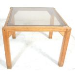 A vintage 20th Century 1970's teak wood and framed glass top coffee / occasional table of square